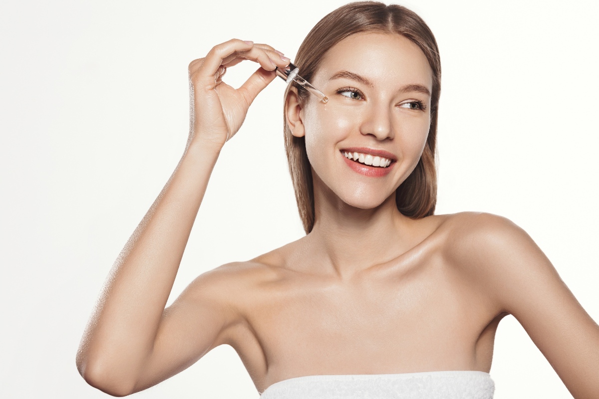 Applicazione di siero viso da parte di una ragazza